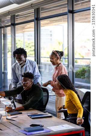 In office, team collaborating using digital devices, sharing ideas enthusiastically In office, team collaborating using digital devices, sharing ideas enthusiastically 135630341