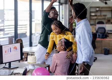 In office, diverse team celebrating birthday, sharing cake and cheerful moment together In office, diverse team celebrating birthday, sharing cake and cheerful moment together 135630362