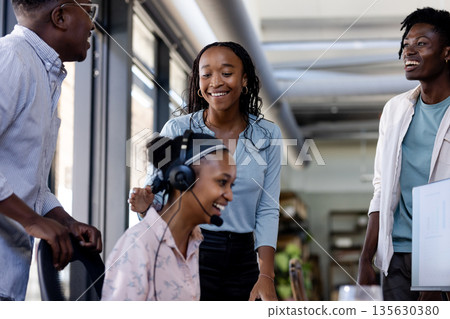 Team collaborating in modern office, smiling and discussing project with enthusiasm Team collaborating in modern office, smiling and discussing project with enthusiasm 135630380