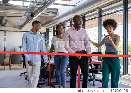Celebrating office opening, business team cutting ribbon together, smiling happily Celebrating office opening, business team cutting ribbon together, smiling happily 135630438