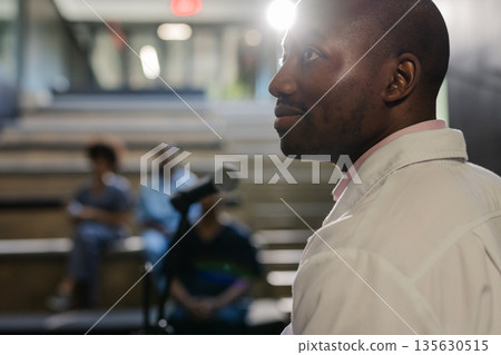 African American man speaking confidently at seminar with audience in background 135630515