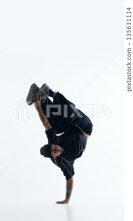 Breakdance acrobatic freeze with legs folded isolated on white studio background 135631114