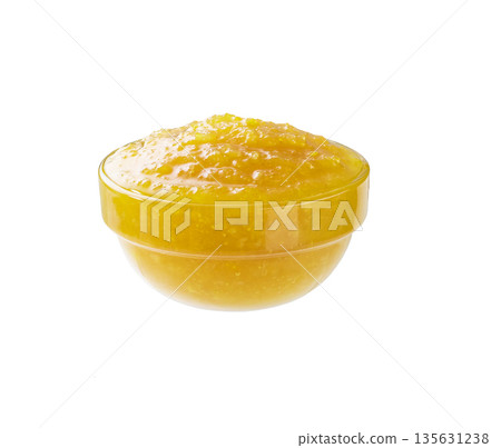 Lemon jam in a clear glass bowl isolated on white background. Lemon jam in a clear glass bowl isolated on white background. 135631238