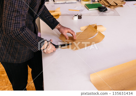 Hand scissor fabric. Cutting fabric closeup. Tailor at work. 135631434