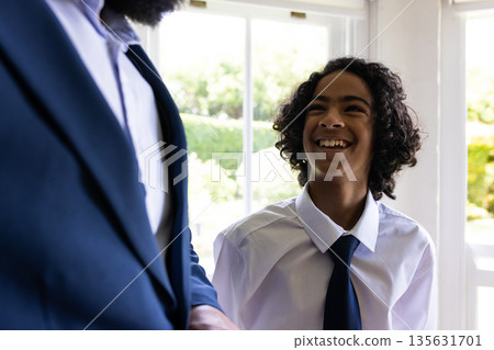 Young boy in formal attire smiling joyfully during bar mitzvah indoors Young boy in formal attire smiling joyfully during bar mitzvah indoors 135631701