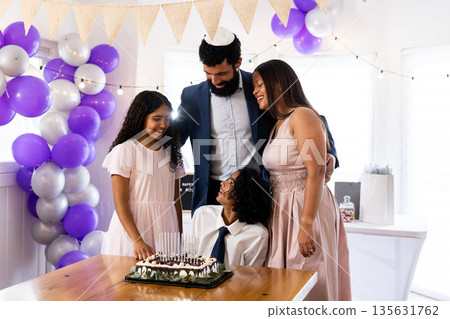 Family celebrating bar mitzvah together with cake and decorations at home Family celebrating bar mitzvah together with cake and decorations at home 135631762