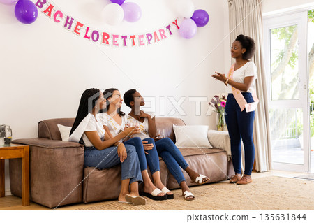 Celebrating bachelorette party, African American women having conversation together at home 135631844
