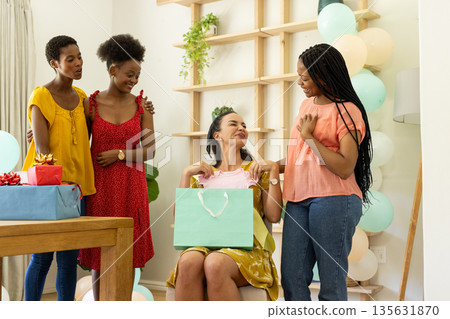 Celebrating birthday, diverse female friends giving gifts and enjoying at home 135631870