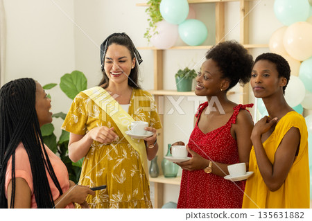 Celebrating together, diverse female friends enjoying tea and conversation at home Celebrating together, diverse female friends enjoying tea and conversation at home 135631882