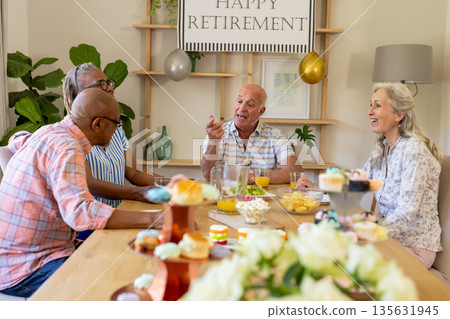 Celebrating retirement at home, senior friends having conversation and snacks together Celebrating retirement at home, senior friends having conversation and snacks together 135631945