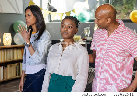African American woman celebrating with friends at home, enjoying festive gathering African American woman celebrating with friends at home, enjoying festive gathering 135632511