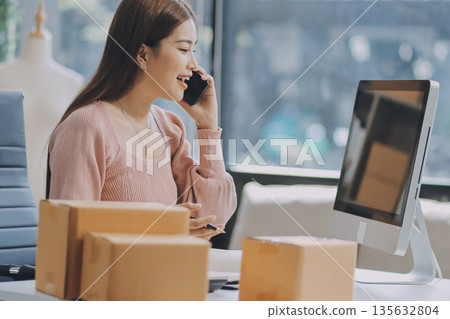 Starting small businesses SME owners female entrepreneurs check online orders to prepare to pack the boxes, sell to customers, sme business ideas online. Starting small businesses SME owners female entrepreneurs check online orders to prepare to pack the boxes, sell to customers, sme business ideas online. 135632804