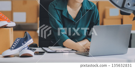 Starting small businesses SME owners female entrepreneurs check online orders to prepare to pack the boxes, sell to customers, sme business ideas online. 135632831