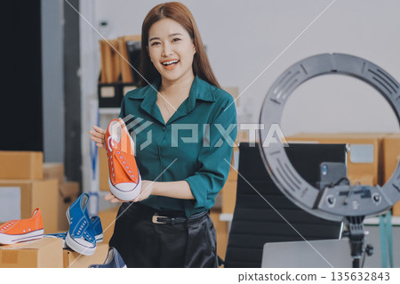 Starting small businesses SME owners female entrepreneurs check online orders to prepare to pack the boxes, sell to customers, sme business ideas online. Starting small businesses SME owners female entrepreneurs check online orders to prepare to pack the boxes, sell to customers, sme business ideas online. 135632843