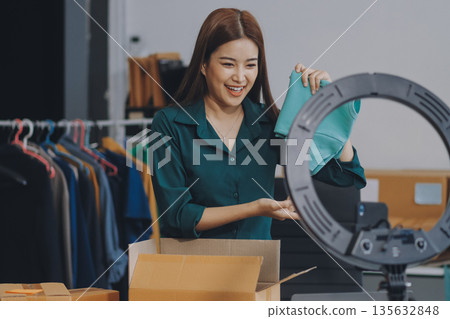 Starting small businesses SME owners female entrepreneurs check online orders to prepare to pack the boxes, sell to customers, sme business ideas online. 135632848