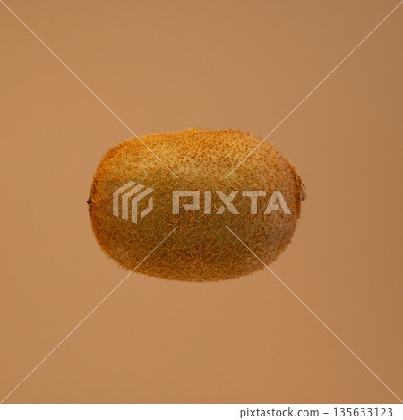 A kiwi fruit is shown in the air A kiwi fruit is shown in the air 135633123