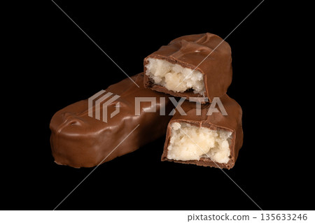 Three chocolate bars with one of them cut in half 135633246