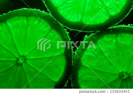 Three green lime slices are shown in a close up Three green lime slices are shown in a close up 135633451