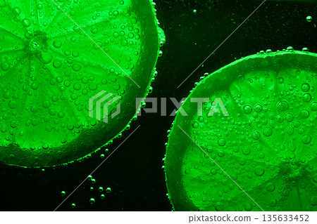 Two green citrus fruits with bubbles on them 135633452