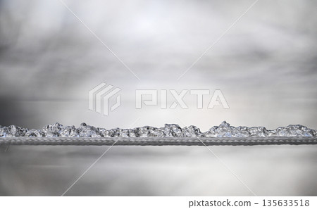 A long, thin line of ice crystals is suspended in the air 135633518