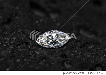 A diamond is sitting on a black surface A diamond is sitting on a black surface 135633732