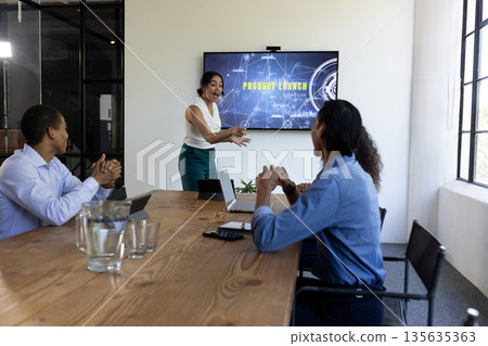 Business team discussing product launch presentation in modern conference room 135635363