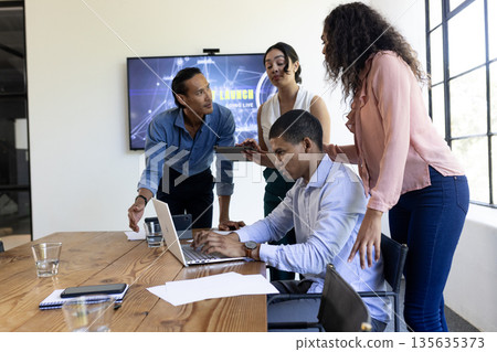Business team collaborating on laptop during meeting in modern office Business team collaborating on laptop during meeting in modern office 135635373
