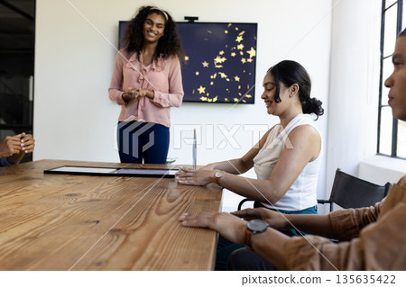 Business team discussing ideas in modern office, smiling and collaborating together Business team discussing ideas in modern office, smiling and collaborating together 135635422