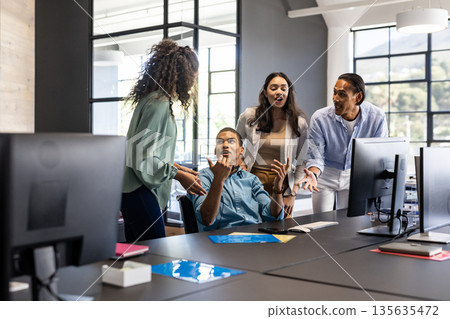 Business team in office discussing project around desk, expressing diverse opinions 135635472