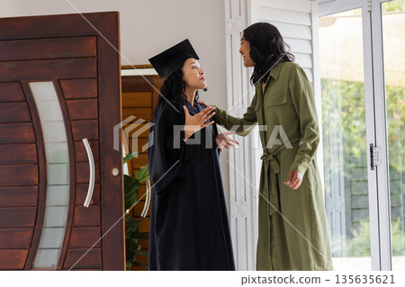 Graduation day, African American mother and daughter celebrating achievement at home Graduation day, African American mother and daughter celebrating achievement at home 135635621