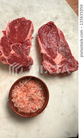 Raw Sirloin Steaks With Pink Salt Crystals On Marble Board, Home Chef Seasoning Moment, Natural Mineral Contrast Against Red Meat, Calm Prep Atmosphere For Intimate Dinner Raw Sirloin Steaks With Pink Salt Crystals On Marble Board, Home Chef Seasoning Moment, Natural Mineral Contrast Against Red Meat, Calm Prep Atmosphere For Intimate Dinner 135635950