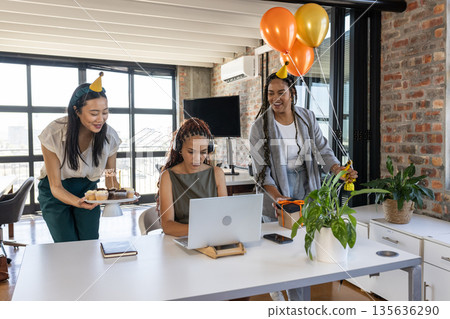 Celebrating birthday in office, colleagues with cupcakes and balloons, smiling joyfully Celebrating birthday in office, colleagues with cupcakes and balloons, smiling joyfully 135636290