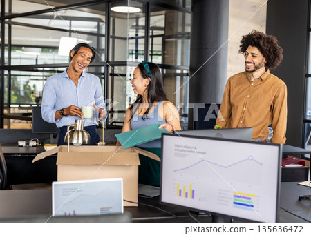 Business team collaborating in modern office, discussing project with enthusiasm 135636472