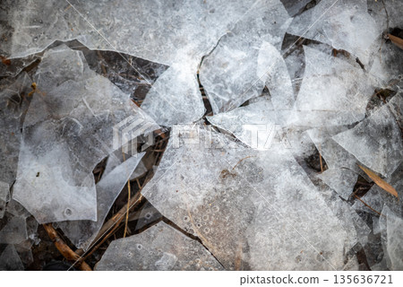 Shattered ice pieces on the ground 135636721