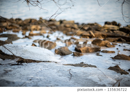 Icy rocky shoreline in winter 135636722