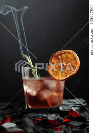 Whiskey with ice, orange slice, and burning rosemary. Whiskey with ice, orange slice, and burning rosemary. 135637064