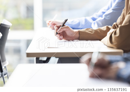 Hands taking the exam 135637191