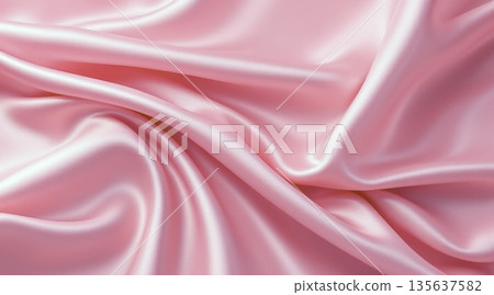 Smooth pink fabric draped with soft folds under bright light from above 135637582