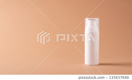 Minimal cosmetic bottle with copy space on beige background Minimal cosmetic bottle with copy space on beige background 135637698
