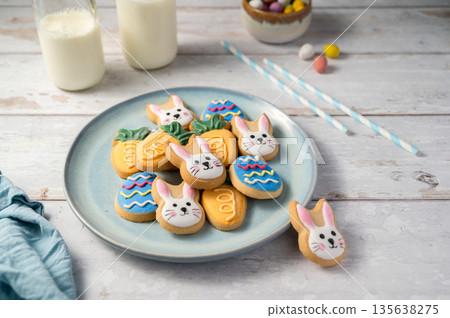 Easter cookies with bottles of milk on white wooden background. Spring holidays background Easter cookies with bottles of milk on white wooden background. Spring holidays background 135638275
