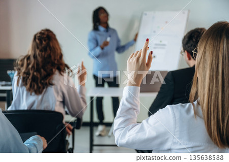 Active discussion. Group of young business people are in conference room Active discussion. Group of young business people are in conference room 135638588