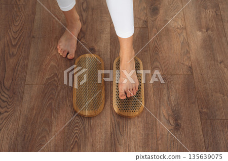 Ready to stand. Close up view of woman's legs that is standing on nails Ready to stand. Close up view of woman's legs that is standing on nails 135639075
