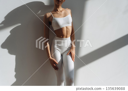 Close up view of woman with slim body type indoors Close up view of woman with slim body type indoors 135639088