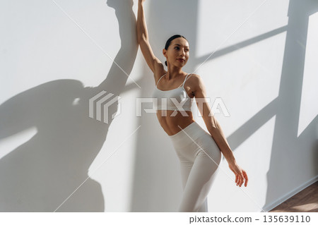 Photo from below. Beautiful young woman with slim body type is indoors Photo from below. Beautiful young woman with slim body type is indoors 135639110