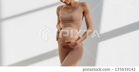 Anticipation conception. Pregnant woman is indoors Anticipation conception. Pregnant woman is indoors 135639142