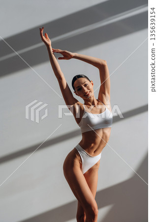 Amazing sunlight. Beautiful young woman with slim body type is indoors 135639154