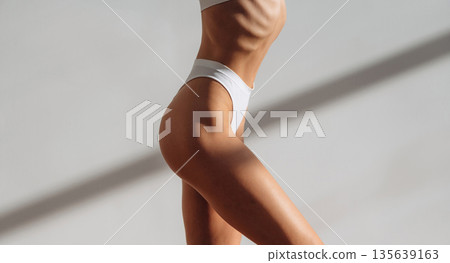 Diet conception. Close up view of woman with slim body type indoors Diet conception. Close up view of woman with slim body type indoors 135639163