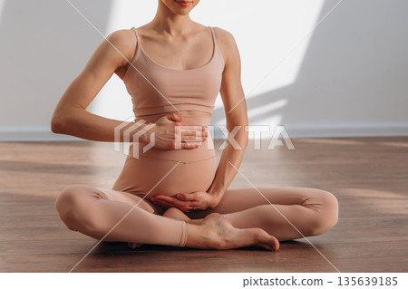 Maternity conception. Pregnant woman is indoors 135639185