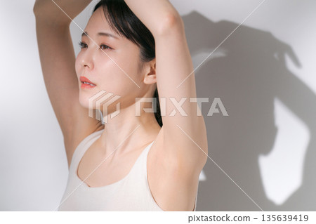 Beauty image of a woman raising her arms Beauty image of a woman raising her arms 135639419