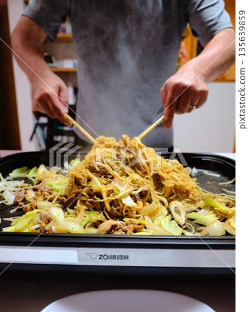 Cooking Yakisoba at a food stall Cooking Yakisoba at a food stall 135639859